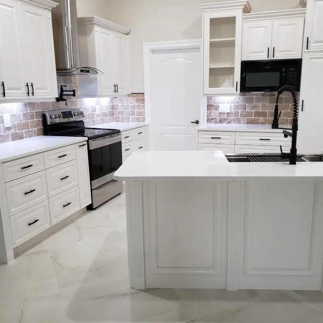 Kitchen island with black faucet and undermount sink