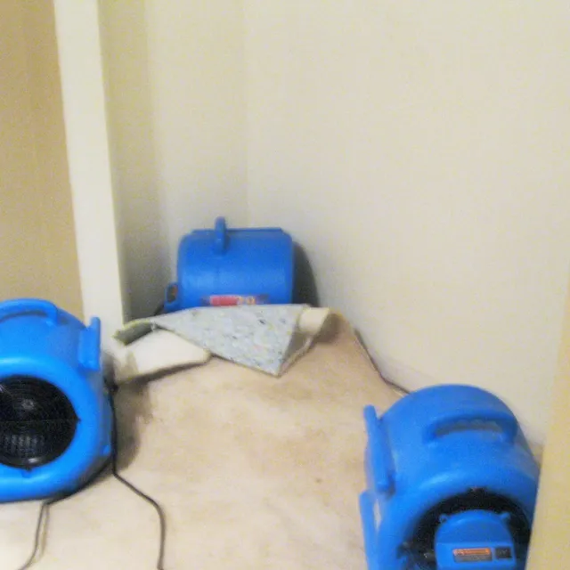 Air movers drying out a water-damaged room