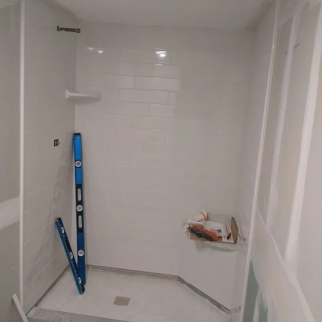 White subway tile shower during installation