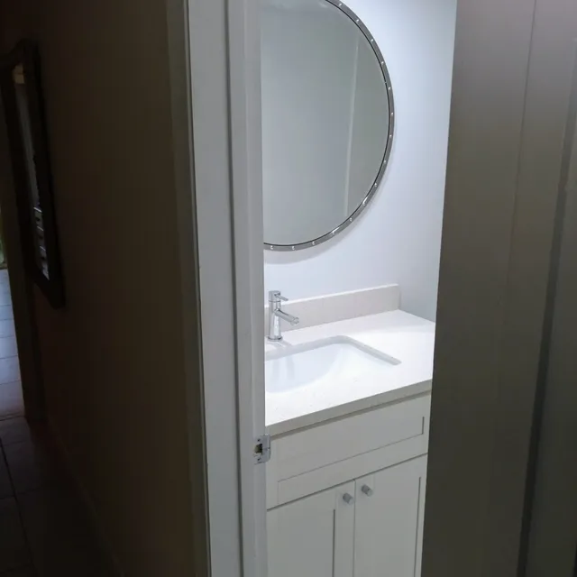 Bathroom vanity with a round mirror