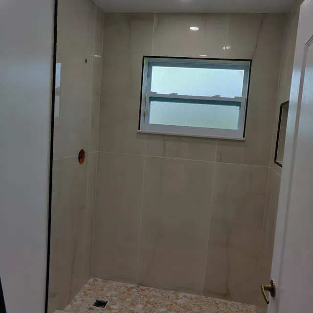 Large-format tile shower with window