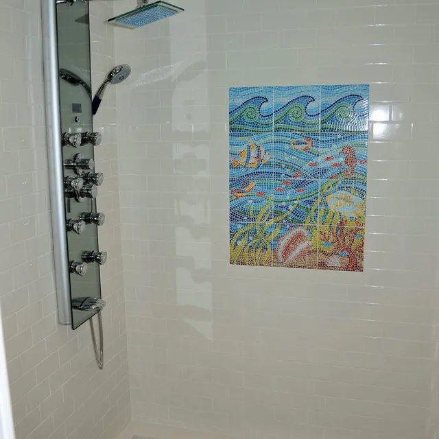 White tile shower with shower panel and decorative tile mural
