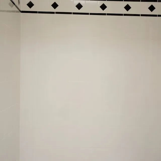 Tiled bathroom wall with black diamond border