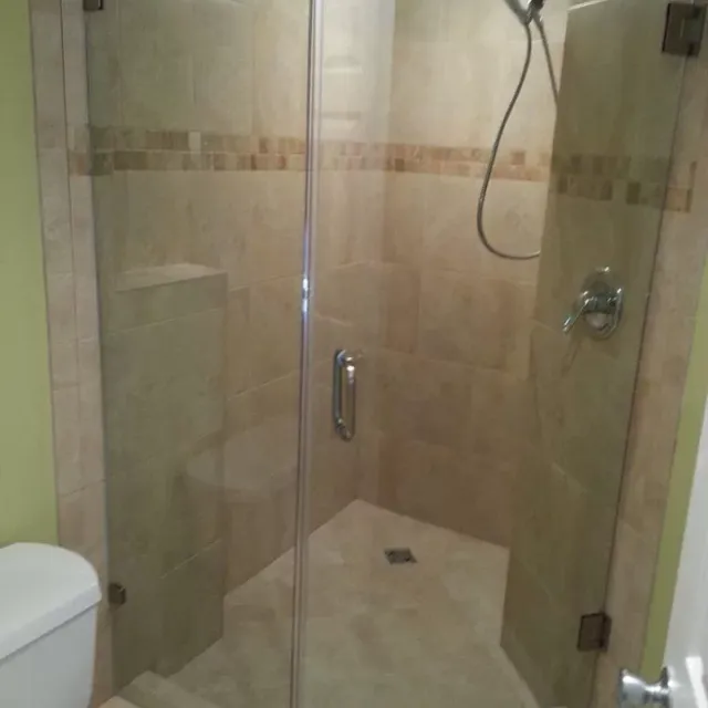 Completed tiled walk-in shower with frameless glass door